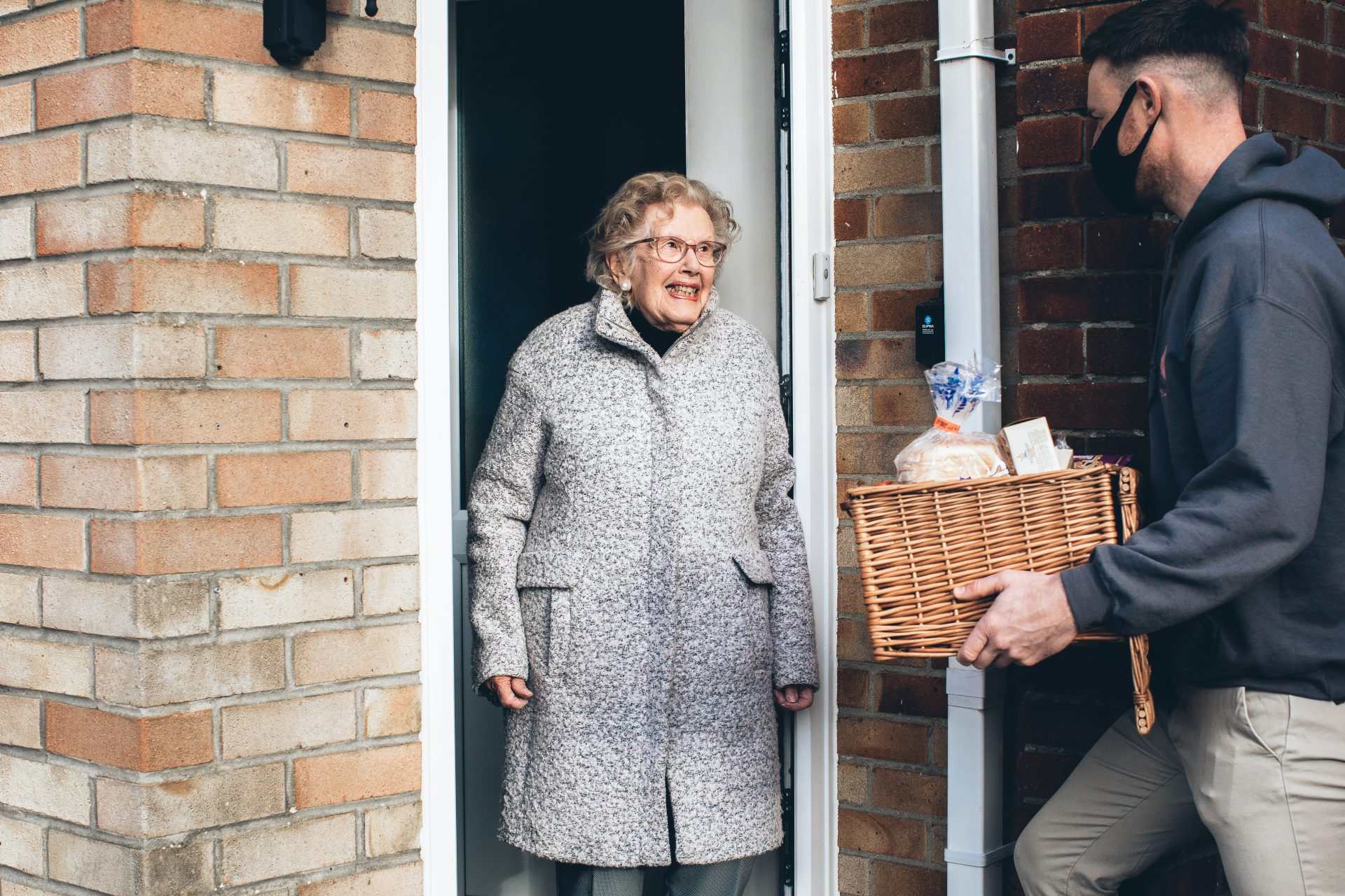 Elderly woman receiving groceries